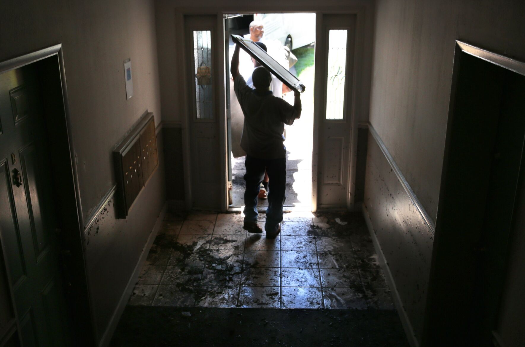 Rescued by boats on Tuesday, apartment residents told to leave or risk losing their belongings by week's end